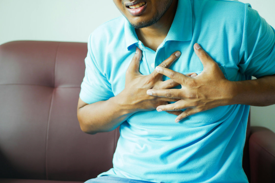 A medical professional reviewing a cardiac scan with advanced technology equipment.